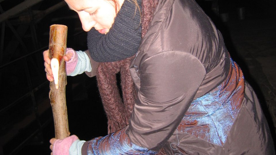 Author of the article Apolena Vynohradnykova during the sound check of one of the "instruments" of the sound installation - microphone attached to the stick with strings is capturing sounds of the water in the underground sedimentation chamber